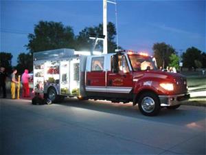 A Larned Fire Engine with lights on at night. 